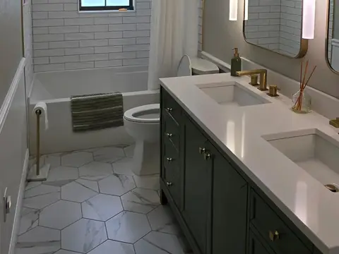 A bathroom with a green double vanity, two sinks in a white counter and hexagon floor tile